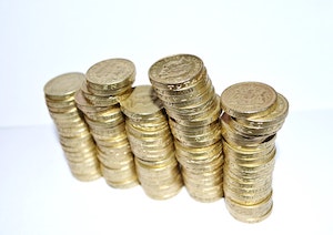 Several stacks of pound coins to illustrate how much interest you earn on a million pounds