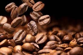 A photo of some coffee beans cascading, to illustrate how money falls away as per the latte factor.